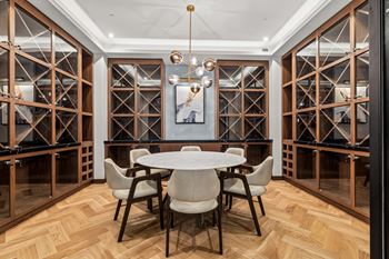 A dining room with a white table and chairs.